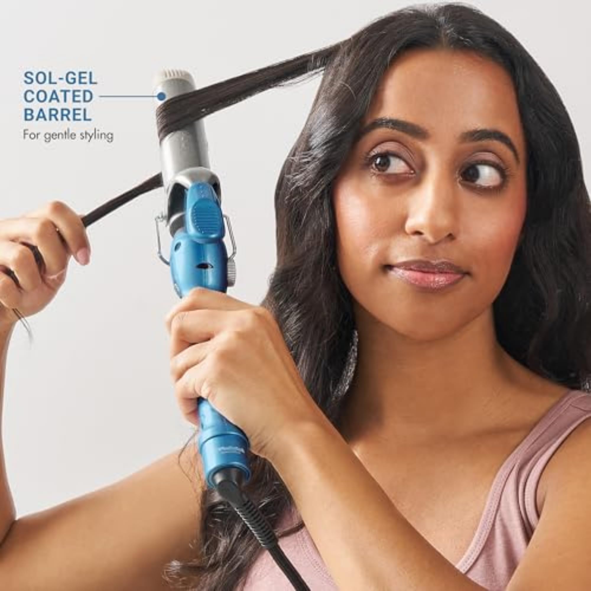 Professional hair wand showcasing the spring clamp mechanism and electronic temperature dial controls