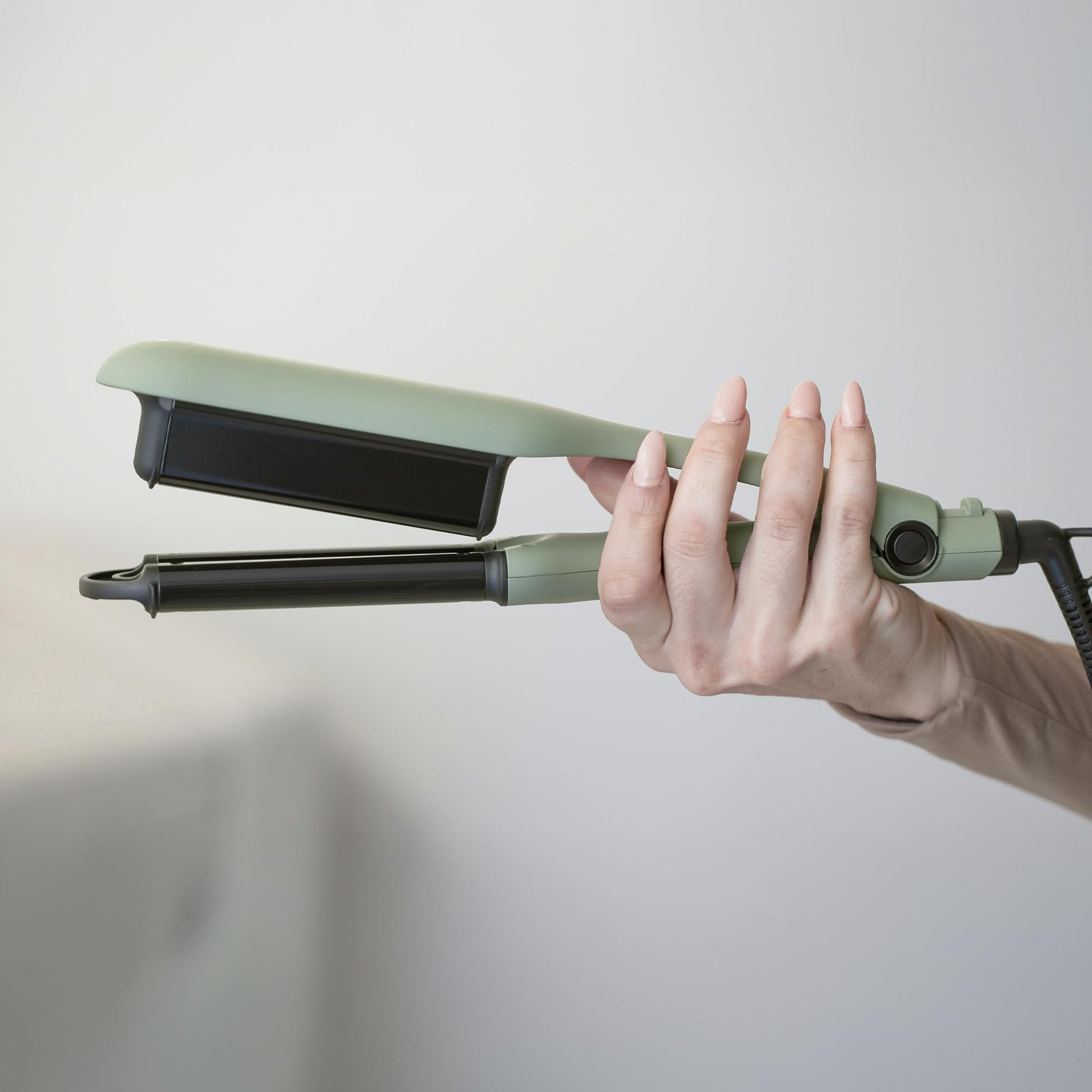 Side profile of the triple barrel waver mechanism displaying the professional swivel cord