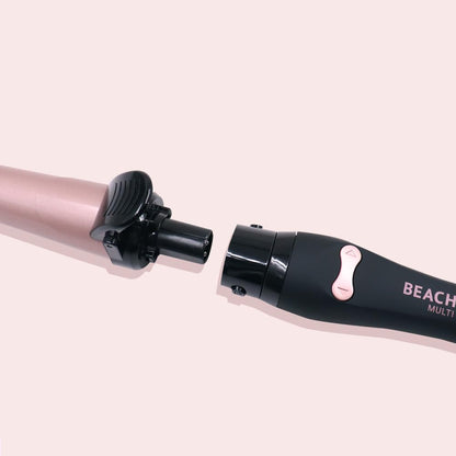 Professional automatic rotating hair curler by The Beachwaver Co with three styling attachments and arrow control buttons