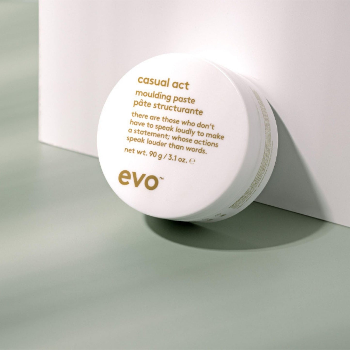 EVO Casual Act hair paste jar next to its protective outer box packaging