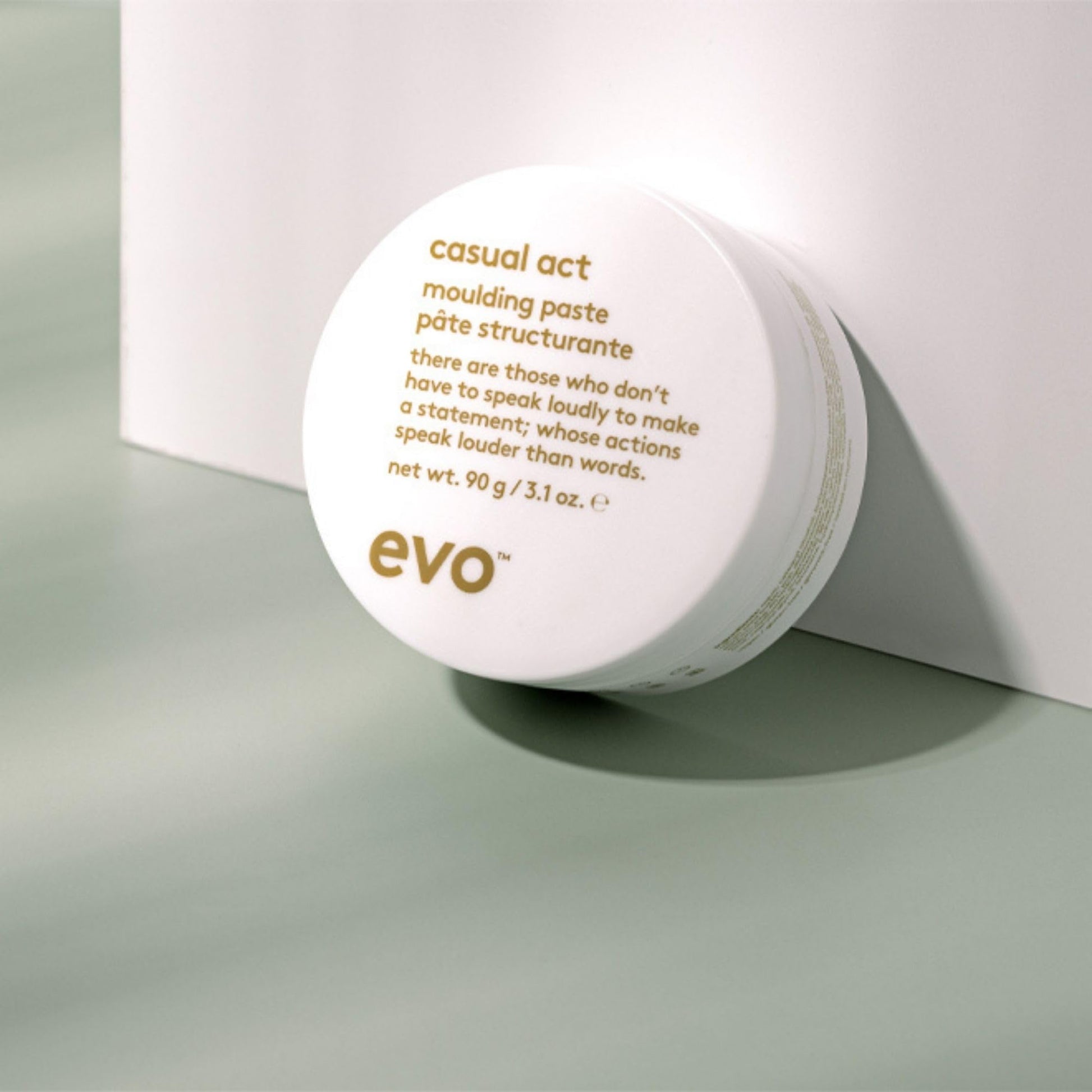 EVO Casual Act hair paste jar next to its protective outer box packaging