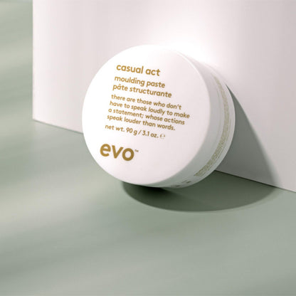 EVO Casual Act hair paste jar next to its protective outer box packaging