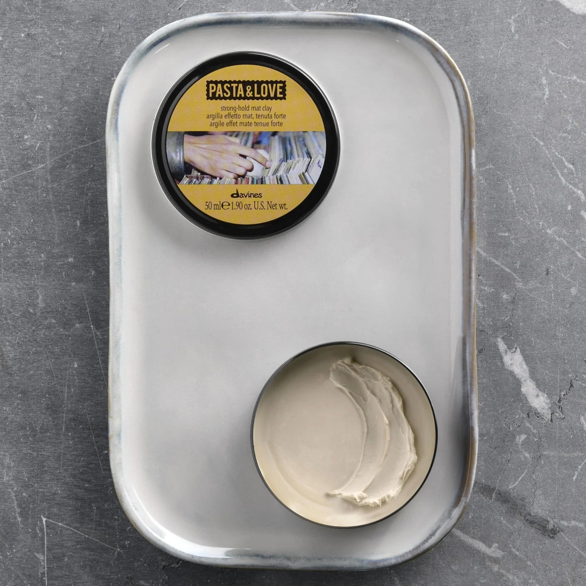 Side profile of Davines strong hold matte clay premium travel friendly tin for hair texture