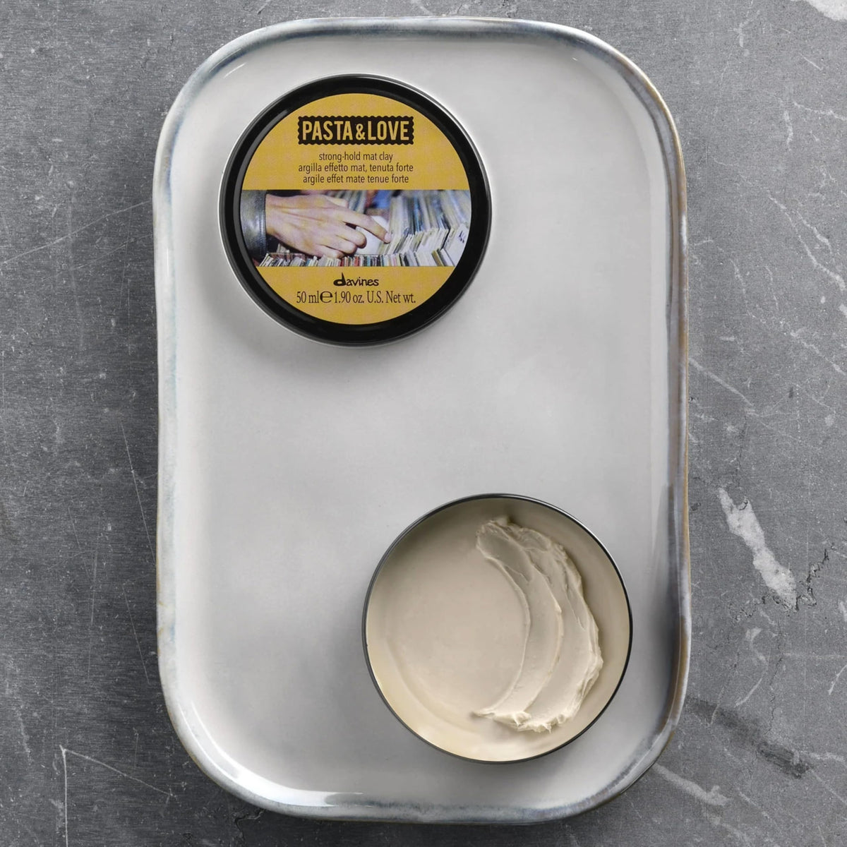 Side profile of Davines strong hold matte clay premium travel friendly tin for hair texture