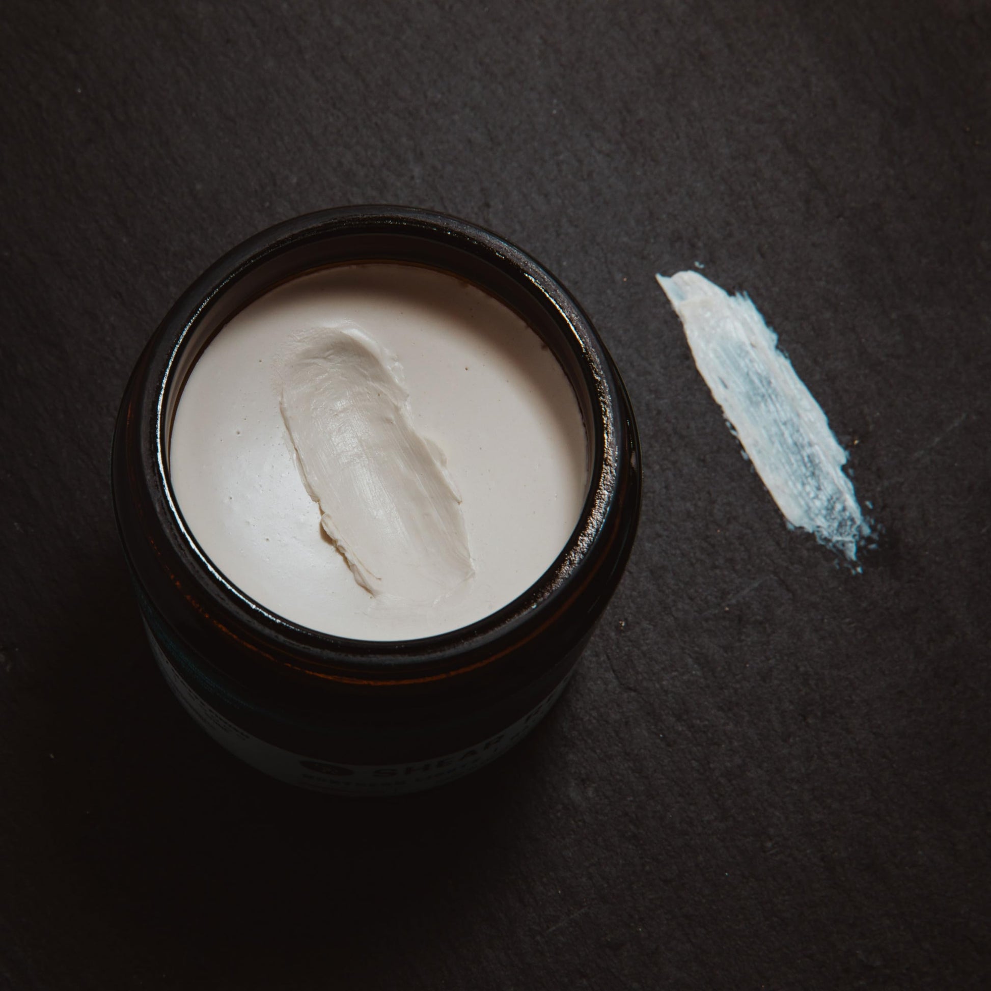 Shear Revival travel friendly hair paste container highlighting the citrus and sage scent formulation