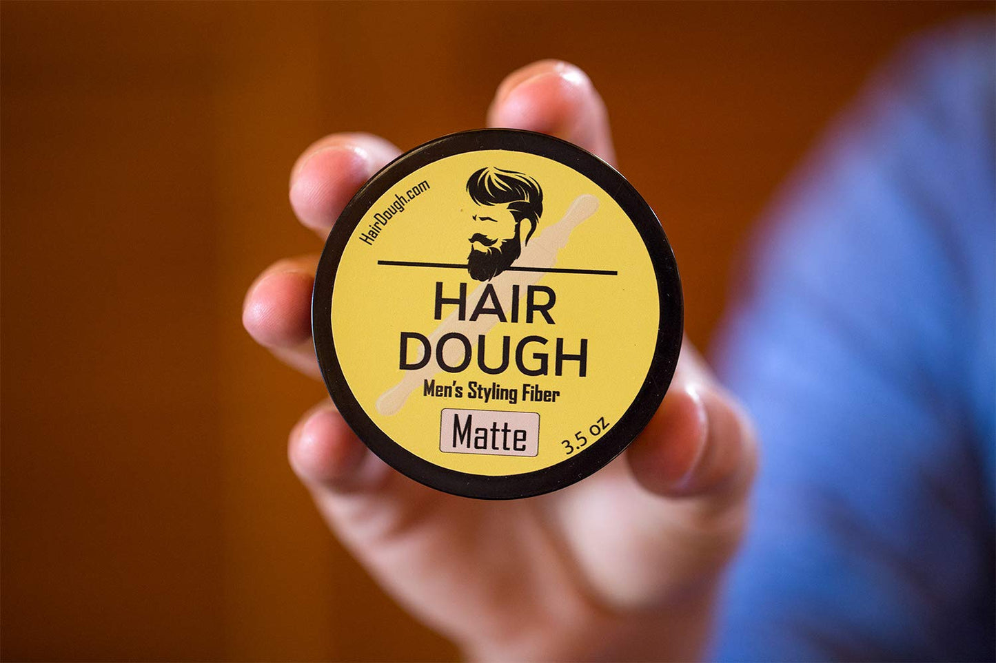 Hair Dough container next to a styled quiff model illustration demonstrating the forty eight hour hold capabilities.