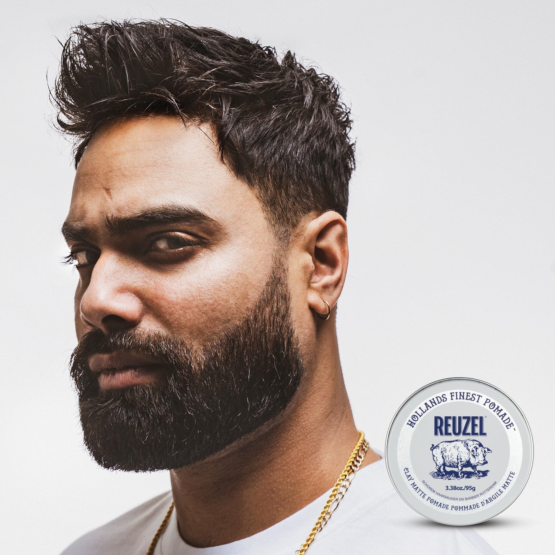 Reuzel vanilla mint scented pomade tin open with texture details visible.