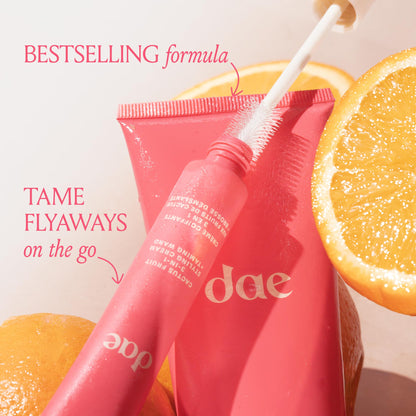 Applying DAE hair styling cream wand to smooth stray baby hairs
