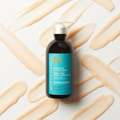 Moroccanoil Hydrating Styling Cream lifestyle shot of the argan oil infused hair product on a sleek vanity countertop.