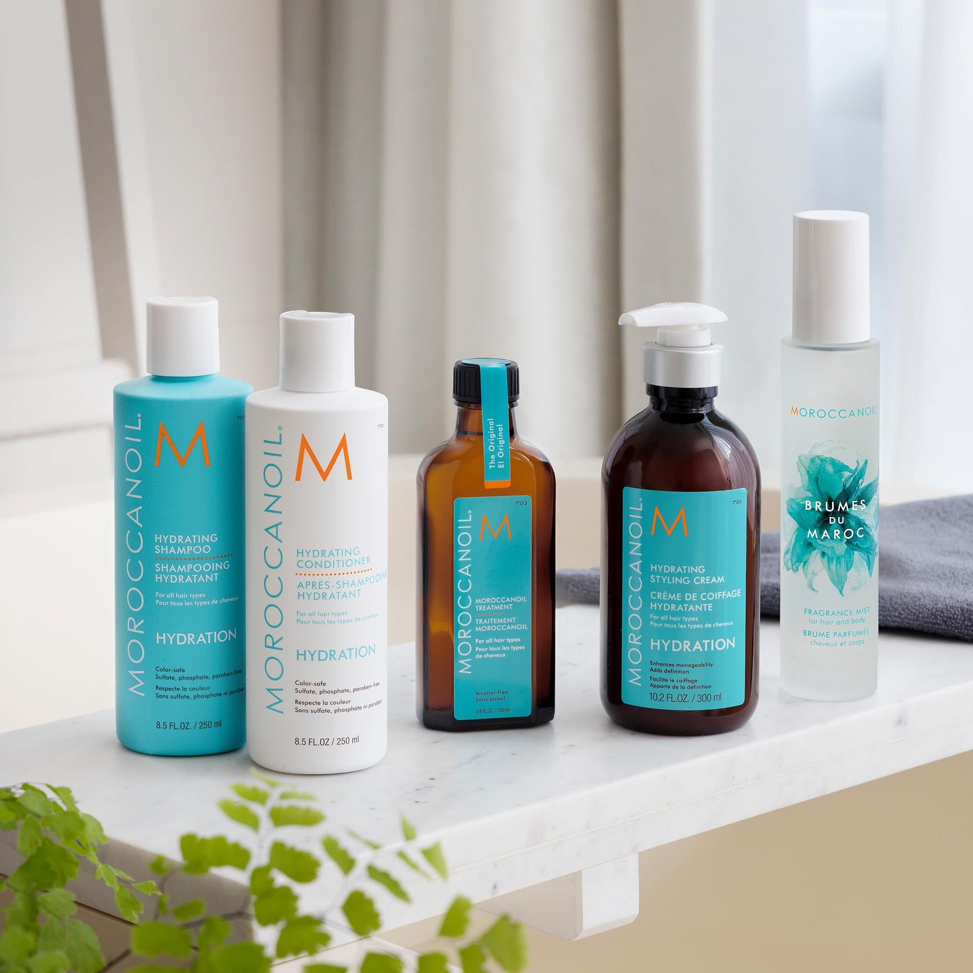 Moroccanoil Hydrating Styling Cream full bottle next to its retail box showing authentic USA import labels.