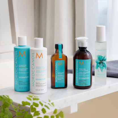 Moroccanoil Hydrating Styling Cream full bottle next to its retail box showing authentic USA import labels.
