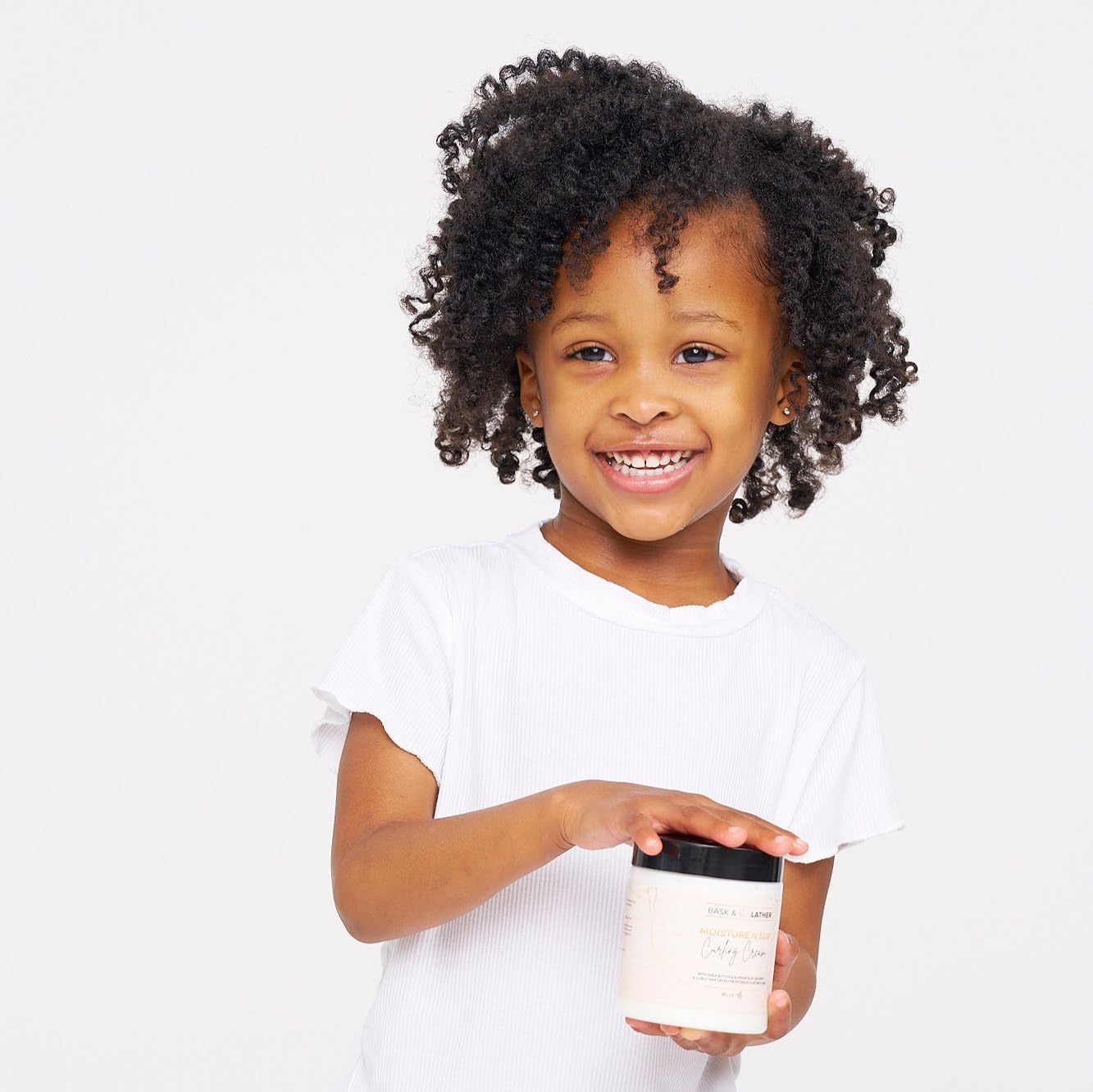 Bask and Lather hair styling cream jar displayed with amaranth and grapeseed oil keywords