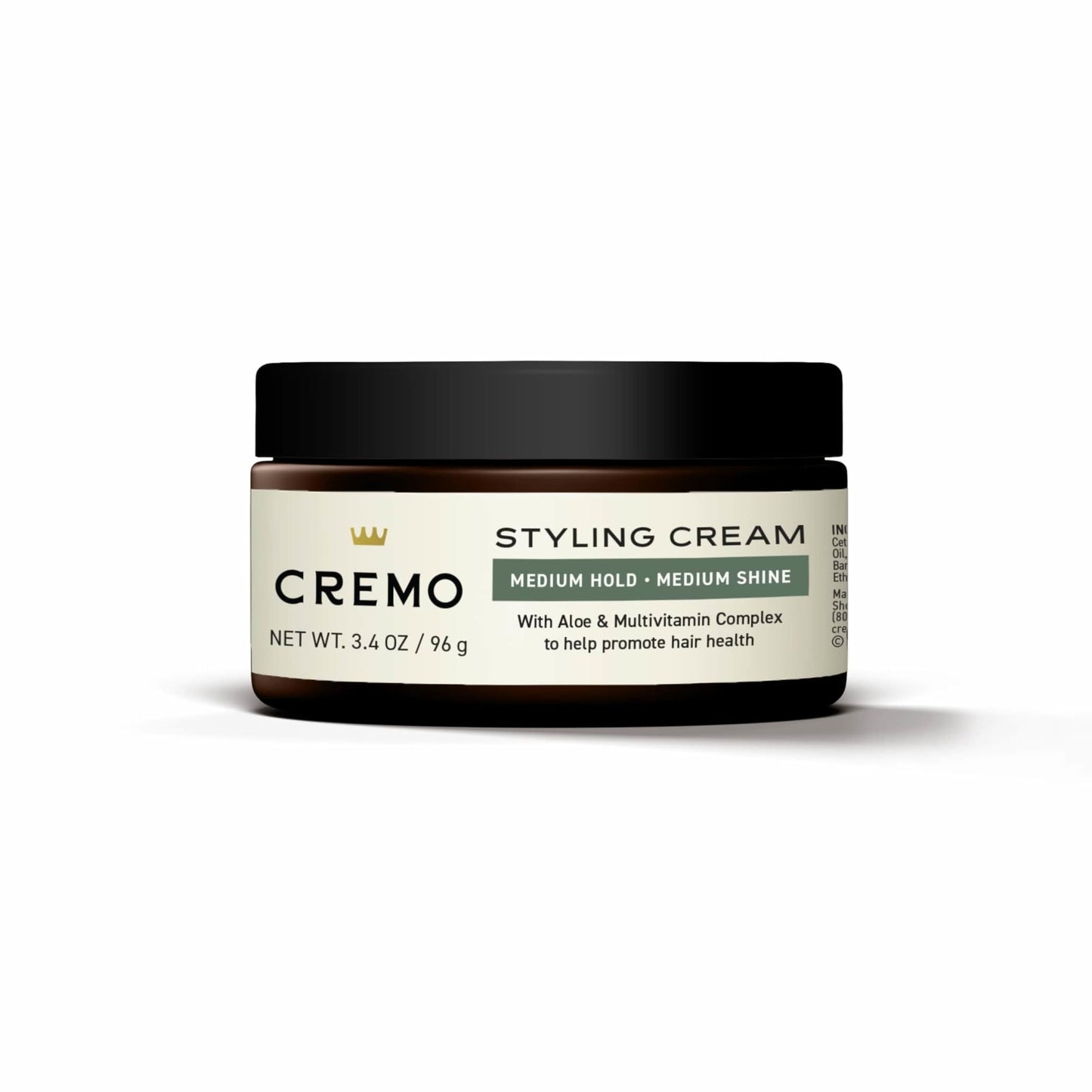 Cremo hair styling cream for men being squeezed out showing smooth white consistency