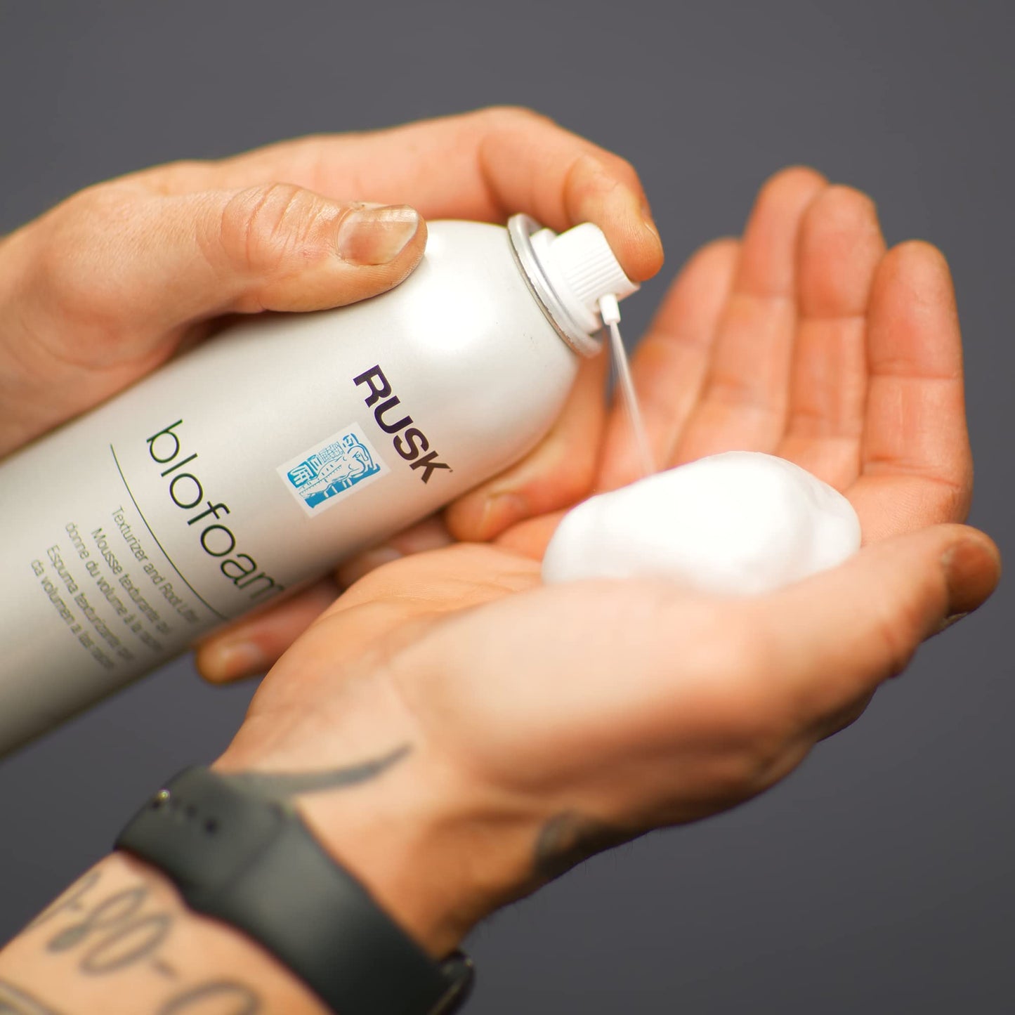 Rusk Designer Collection texturizing mousse canister demonstrating the targeted directional spray nozzle.