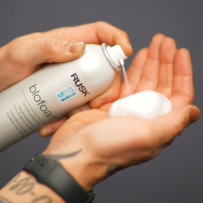 Rusk Designer Collection texturizing mousse canister demonstrating the targeted directional spray nozzle.
