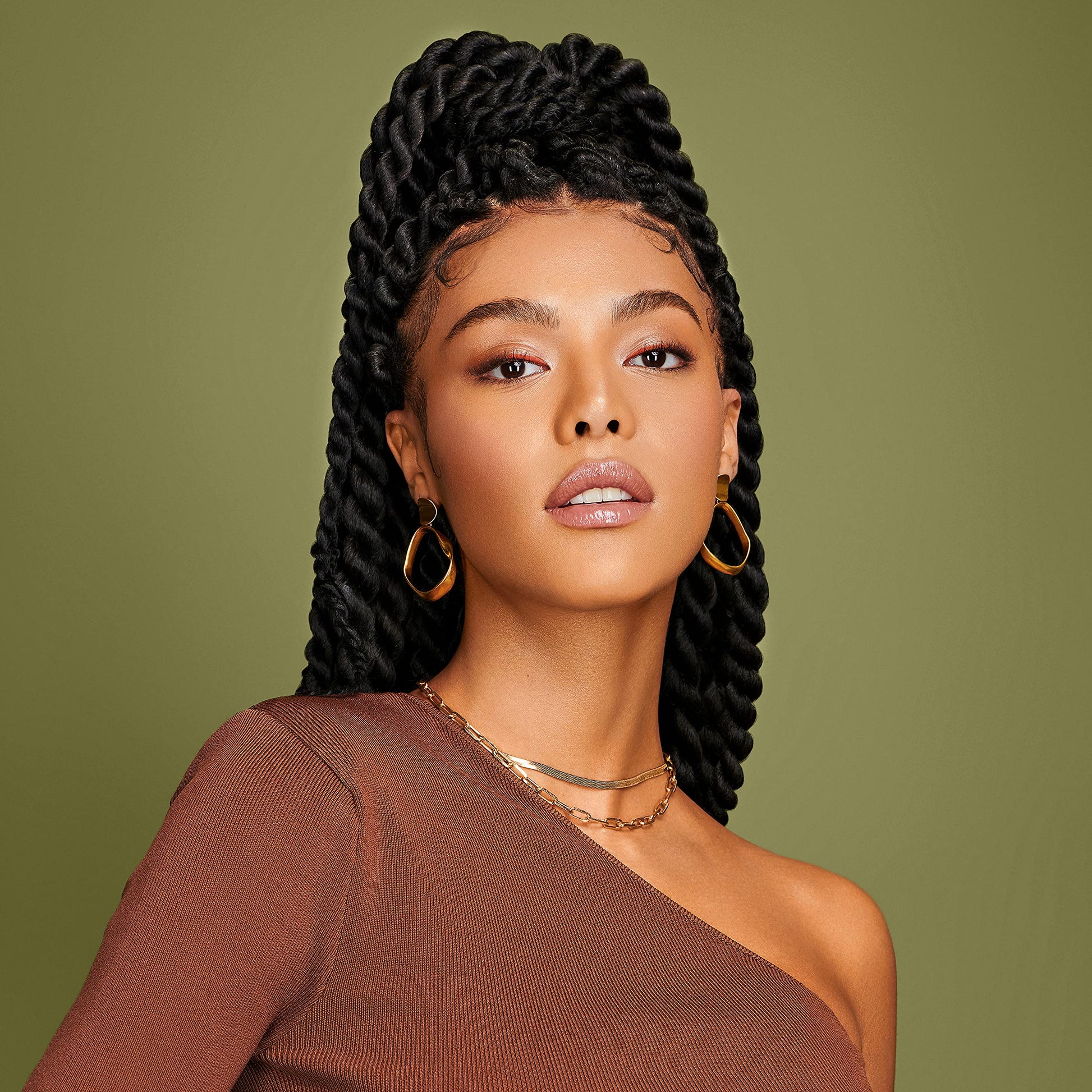 African Pride Olive Miracle setting mousse being pumped out for soft hold styling