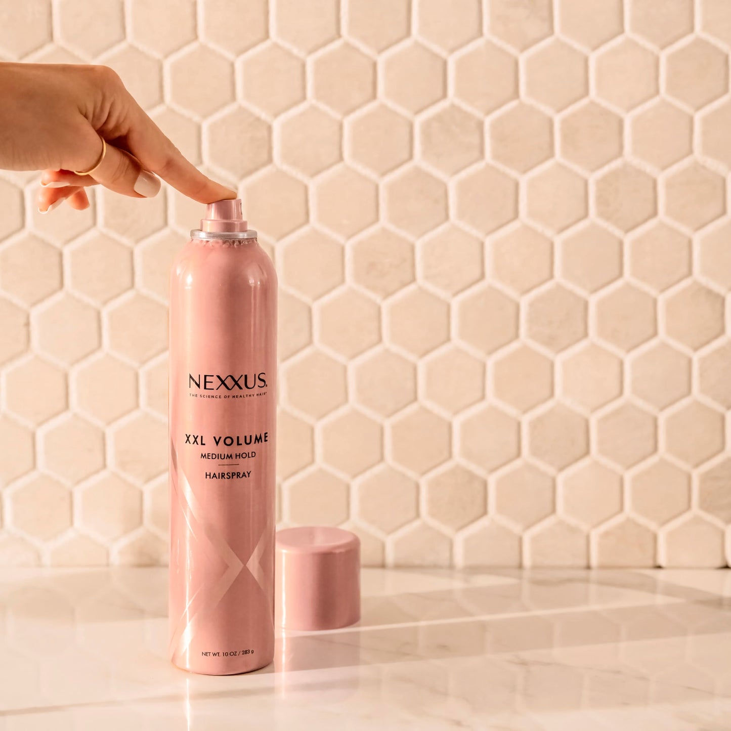 Nexxus XXL finish volume hairspray showcasing the sleek premium packaging layout