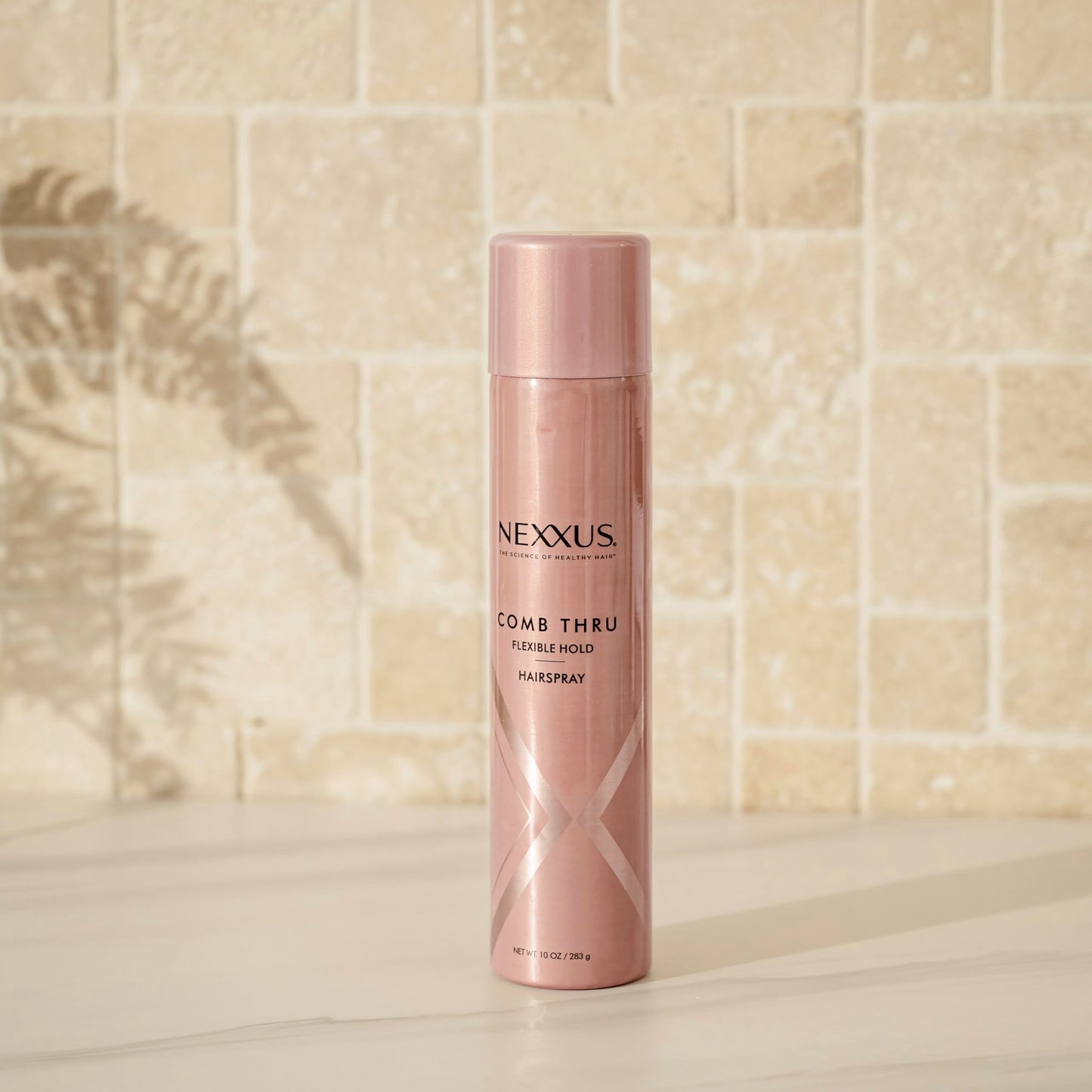 Nexxus anti humidity hair spray bottle displayed on a clean background