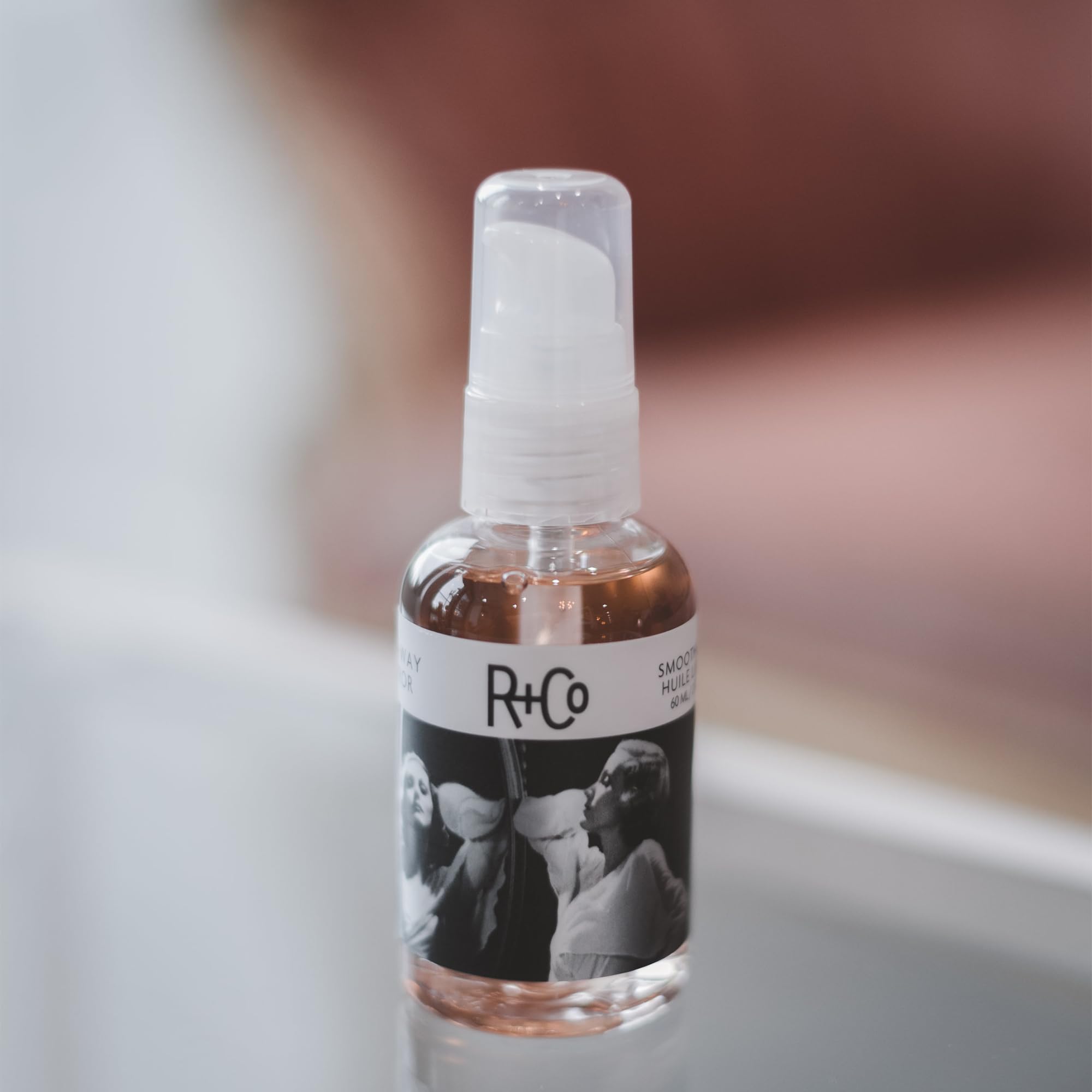 R+Co Two Way Mirror lightweight hair oil application for glossy shine