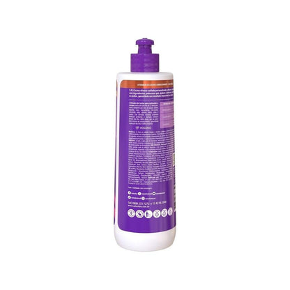 Nourishing leave in curl definition cream bottle highlighting the twelve oil blend formulation.