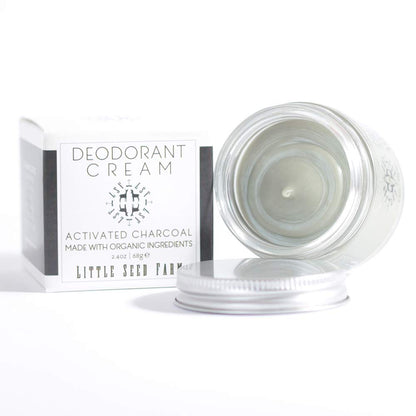 Applying a pea sized amount of natural charcoal deodorant paste on underarms