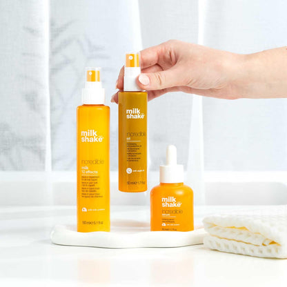 Side view of Milk_Shake premium imported hair oil bottle for healthy hair shine.