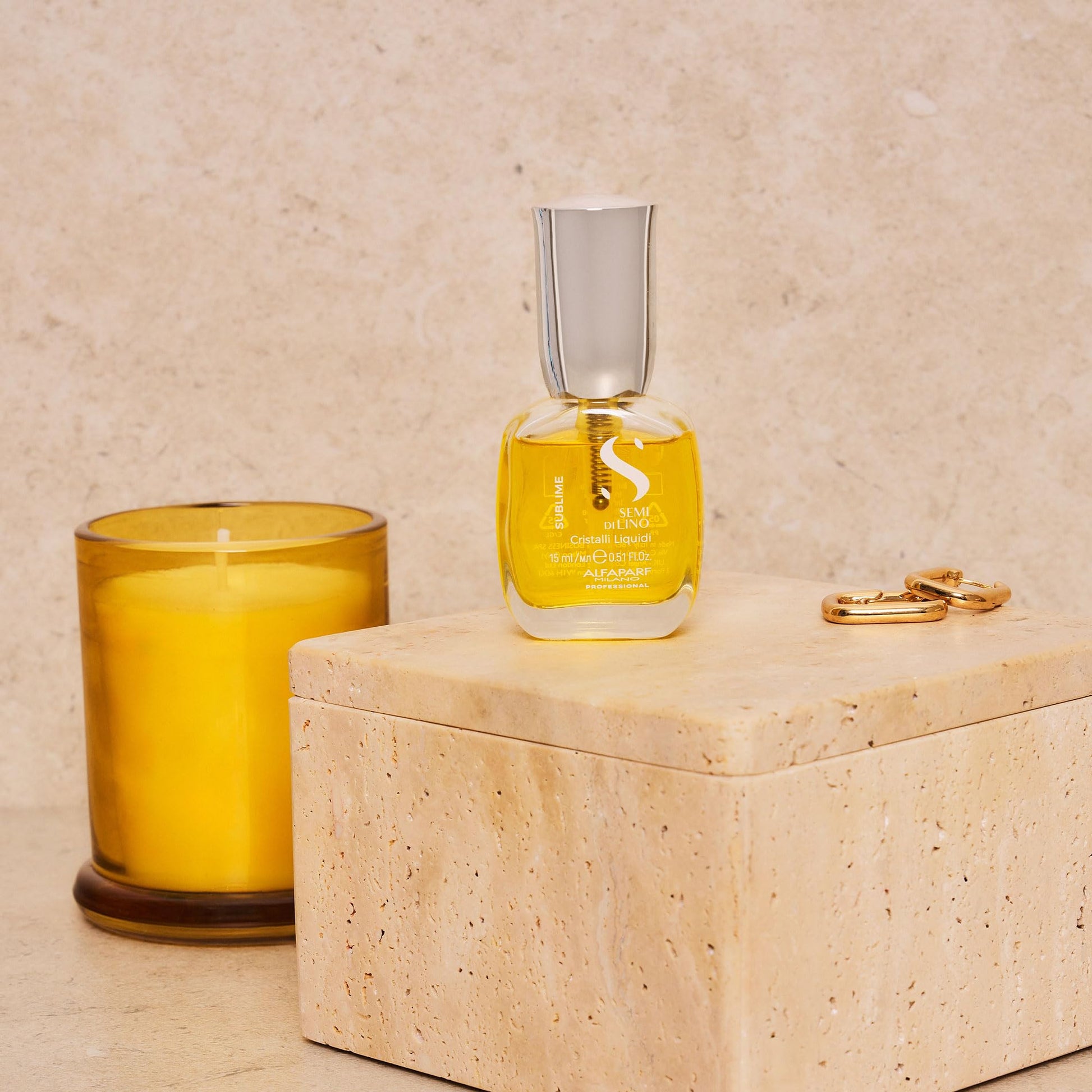 Pouring a drop of the golden flaxseed hair serum from the bottle to demonstrate its lightweight texture.