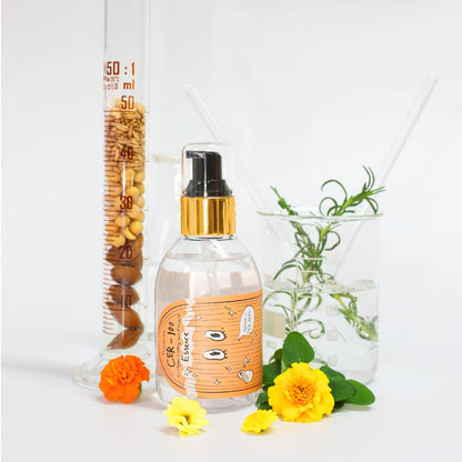 Side view of the 150ml clear bottle demonstrating the golden color of the imported argan and macadamia botanical oil blend.