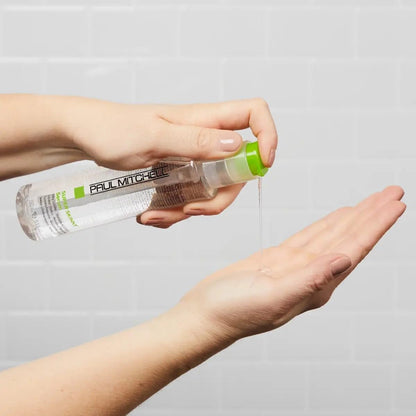 Paul Mitchell smoothing hair serum being dispensed from the green pump to demonstrate concentrated texture