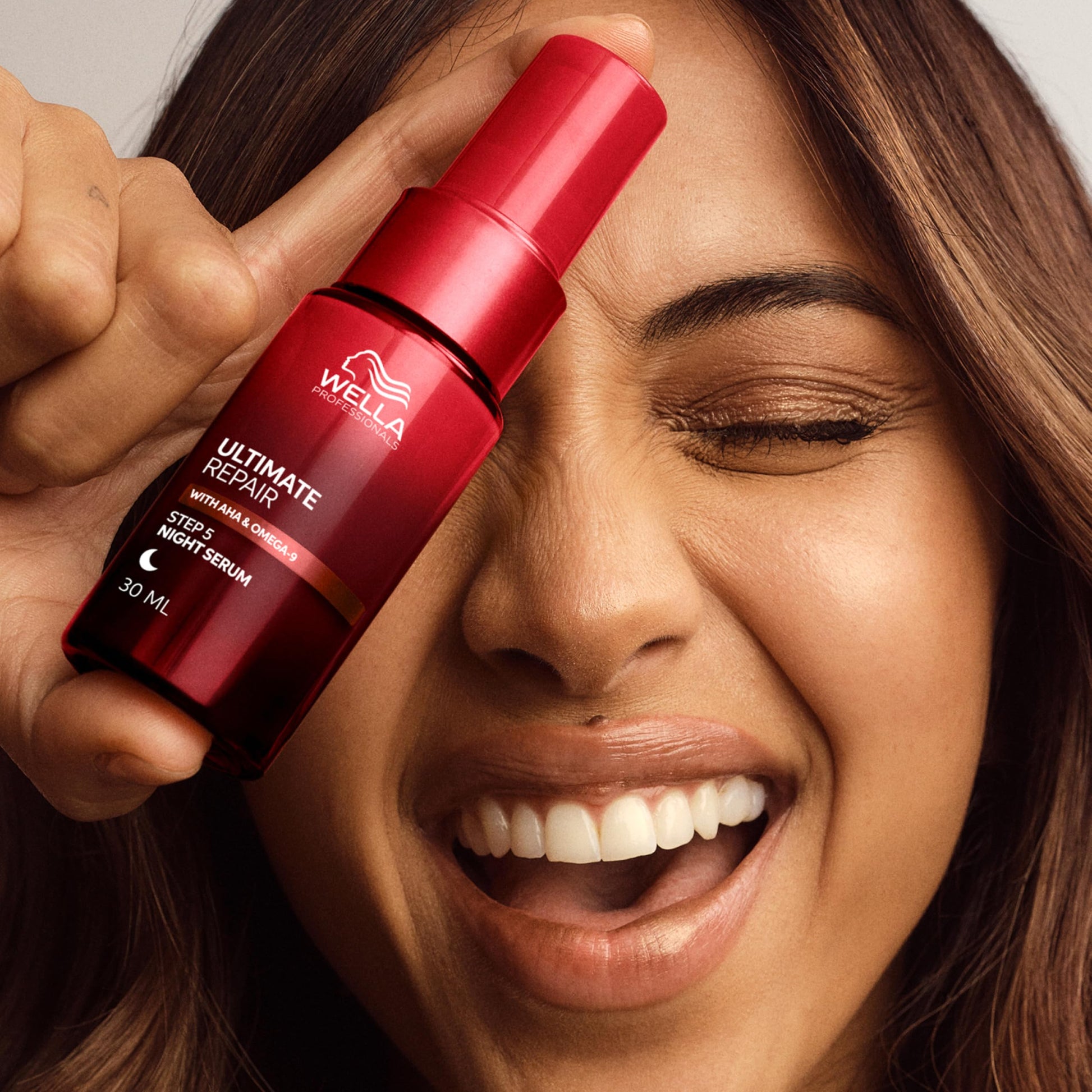 Wella Professionals night hair treatment bottle demonstrating correct pump usage