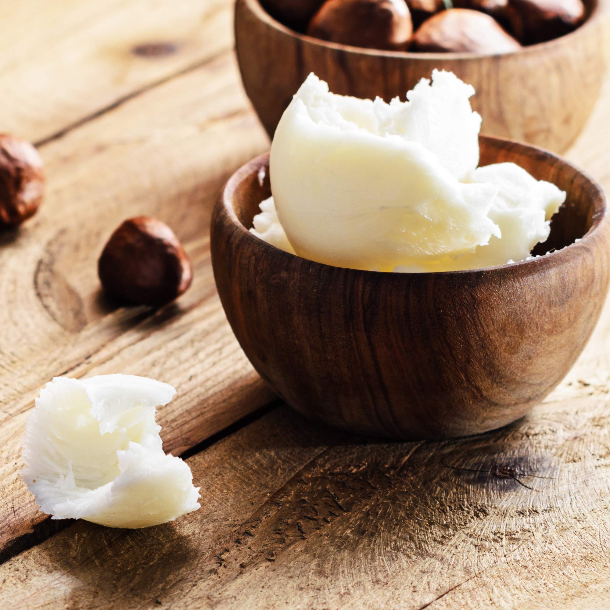 Sheanefit ivory shea butter container on wooden background