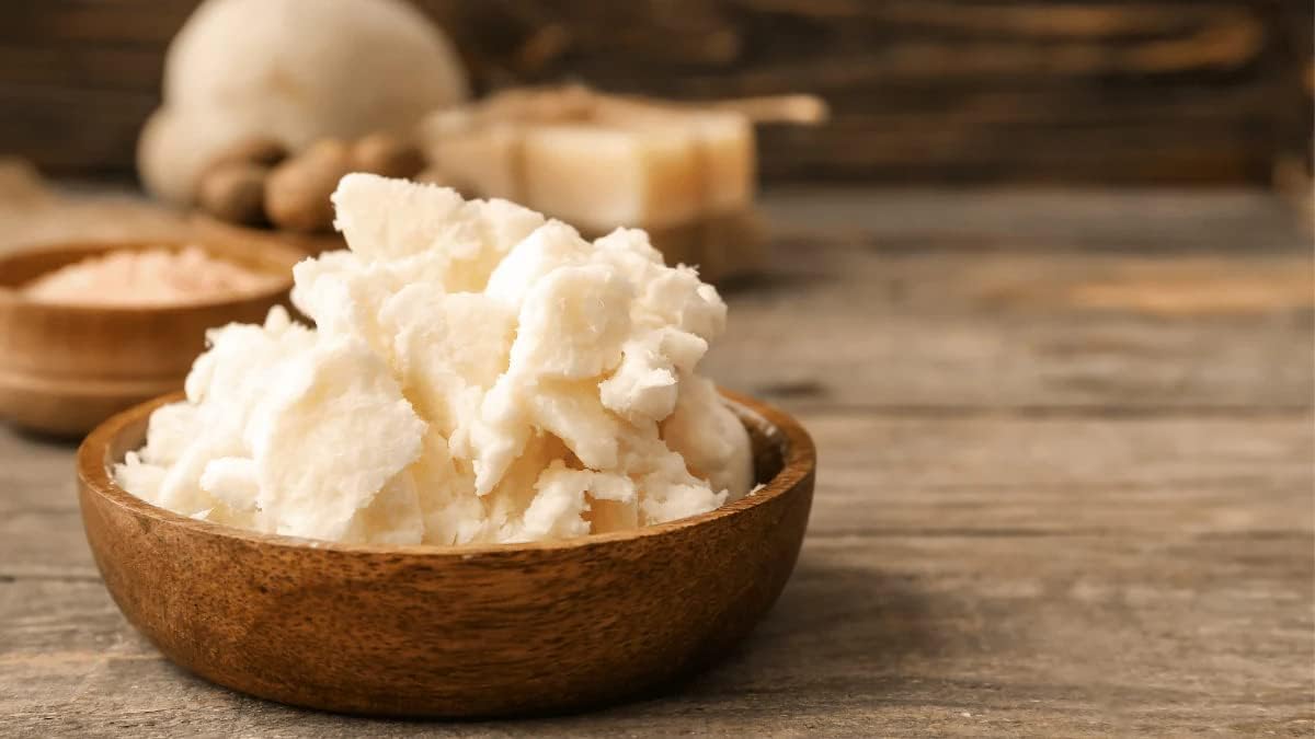 Organic cocoa butter being applied to dry skin