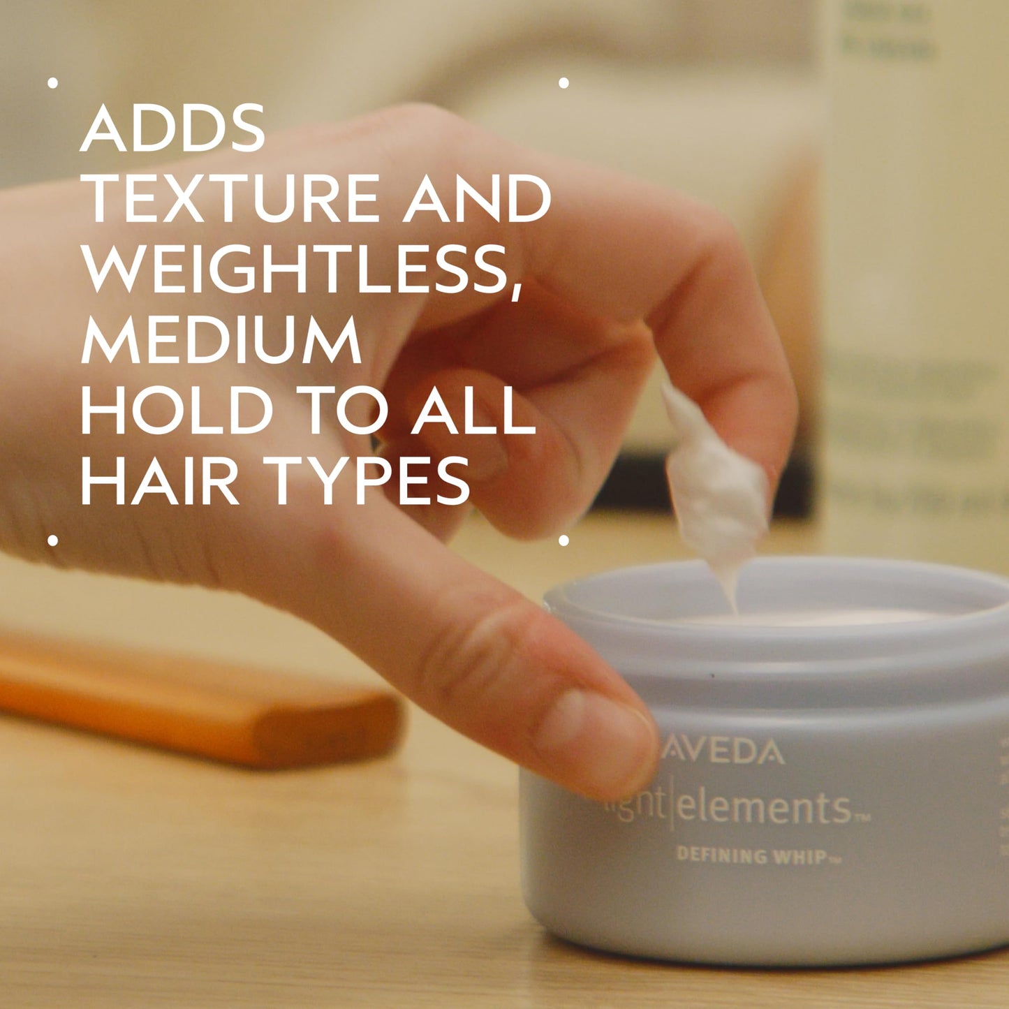Aveda lightweight whipped hair wax jar open revealing the creamy texture