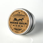 All natural unscented leave in beard conditioner tin showing product labels and benefits.