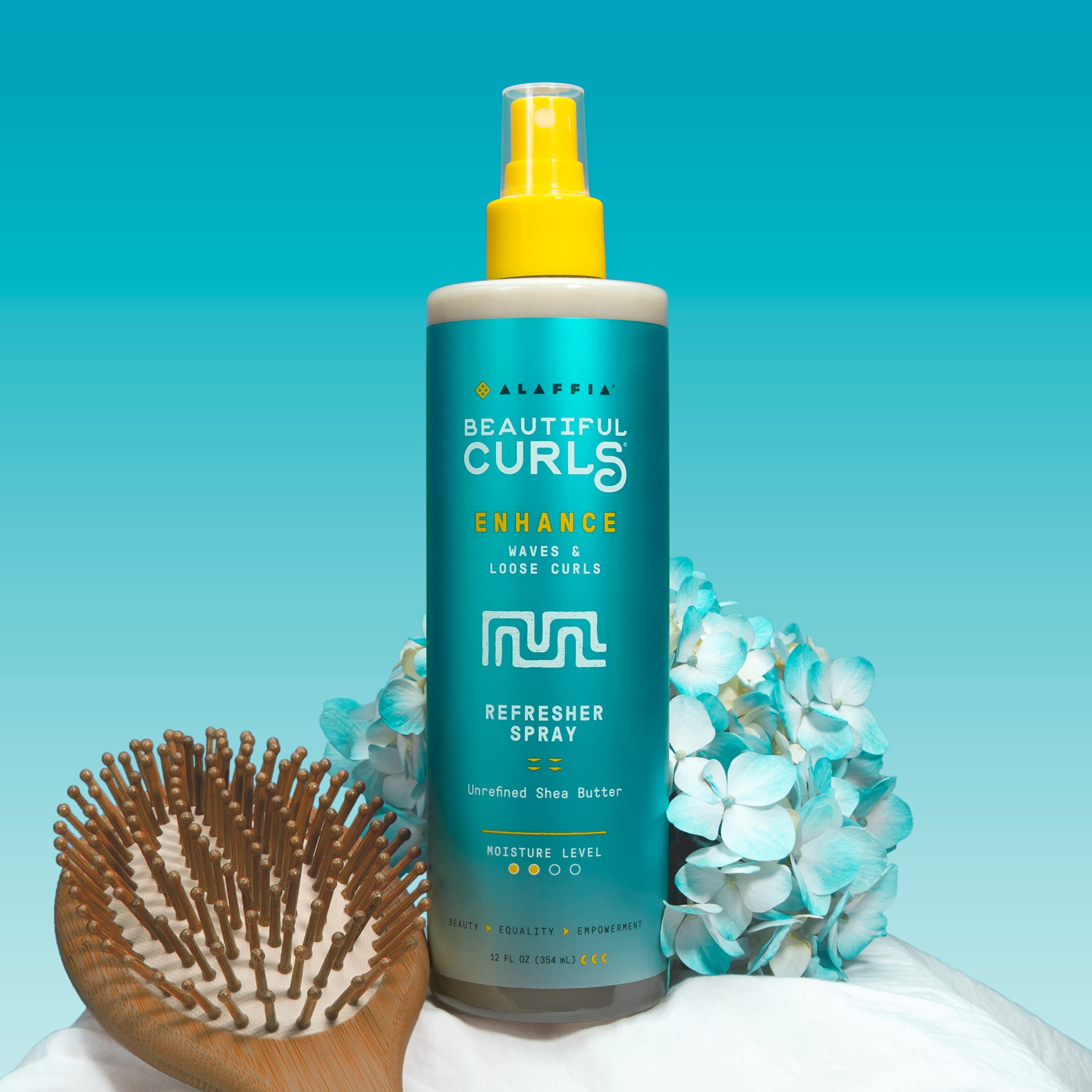 Authentic Alaffia Beautiful Curls spray bottle demonstrating the pump nozzle designed for even mist distribution.