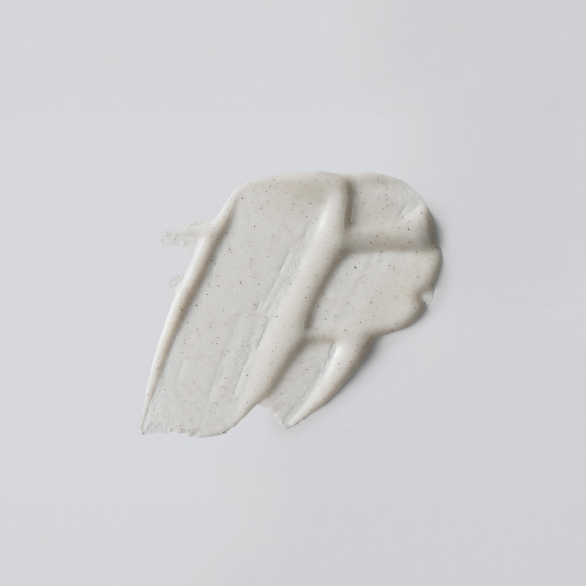 Versed AHA body scrub and mask tube showing chemical exfoliant ingredients
