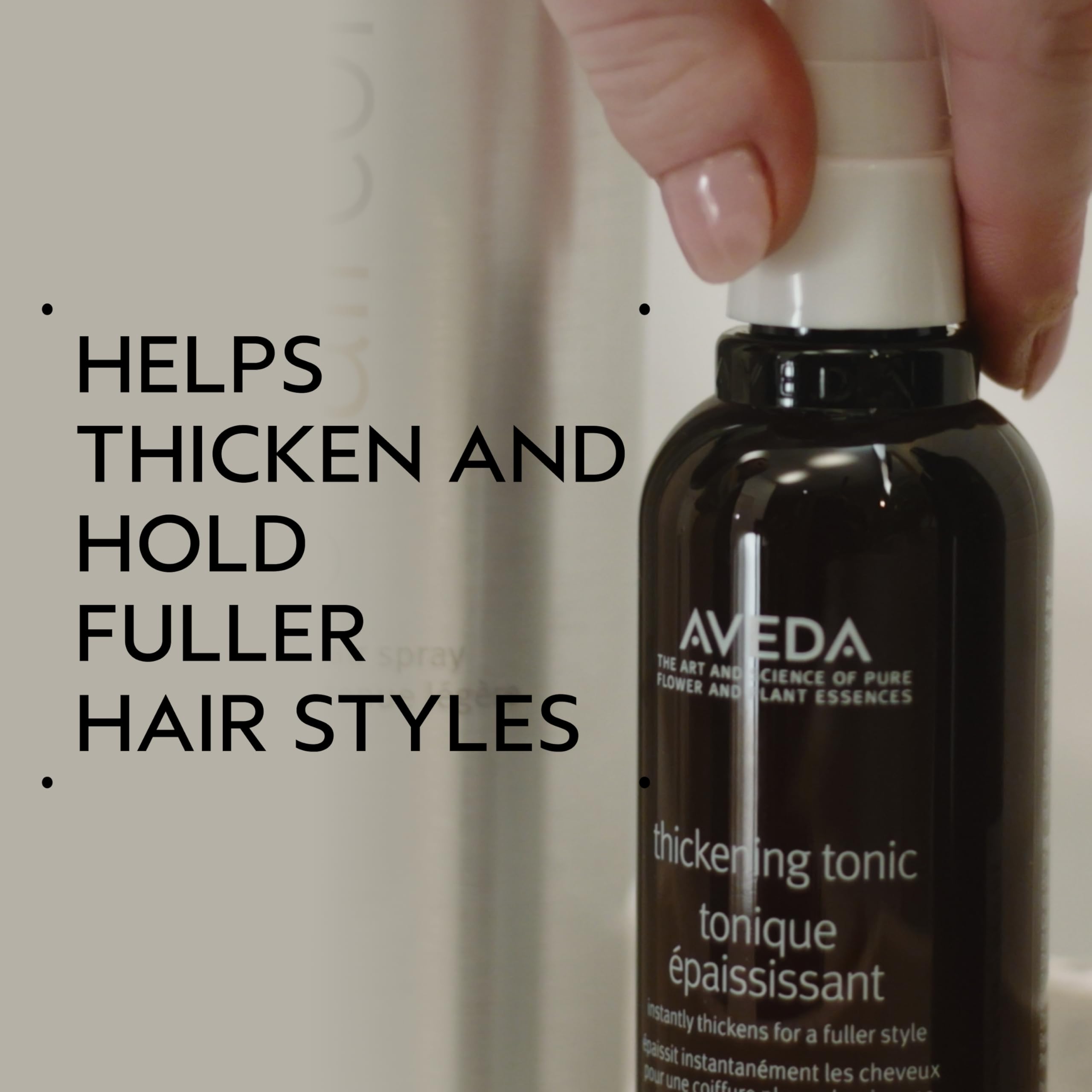 Aveda Thickening Tonic styling spray application on fine hair strands