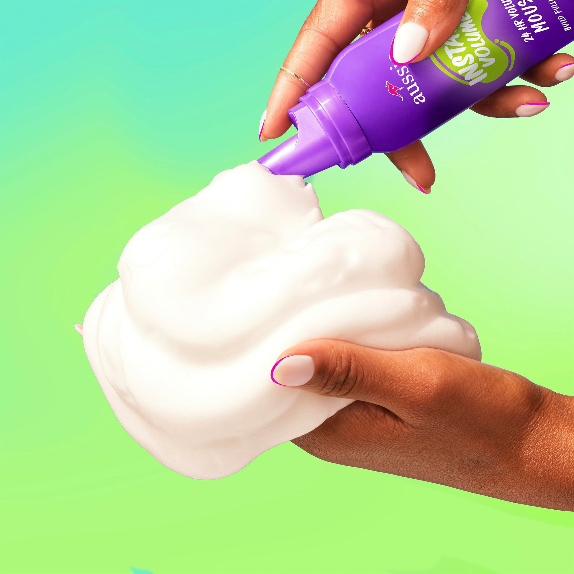 Aussie peachy coconut scented volumizing mousse cans standing upright on a clean background.