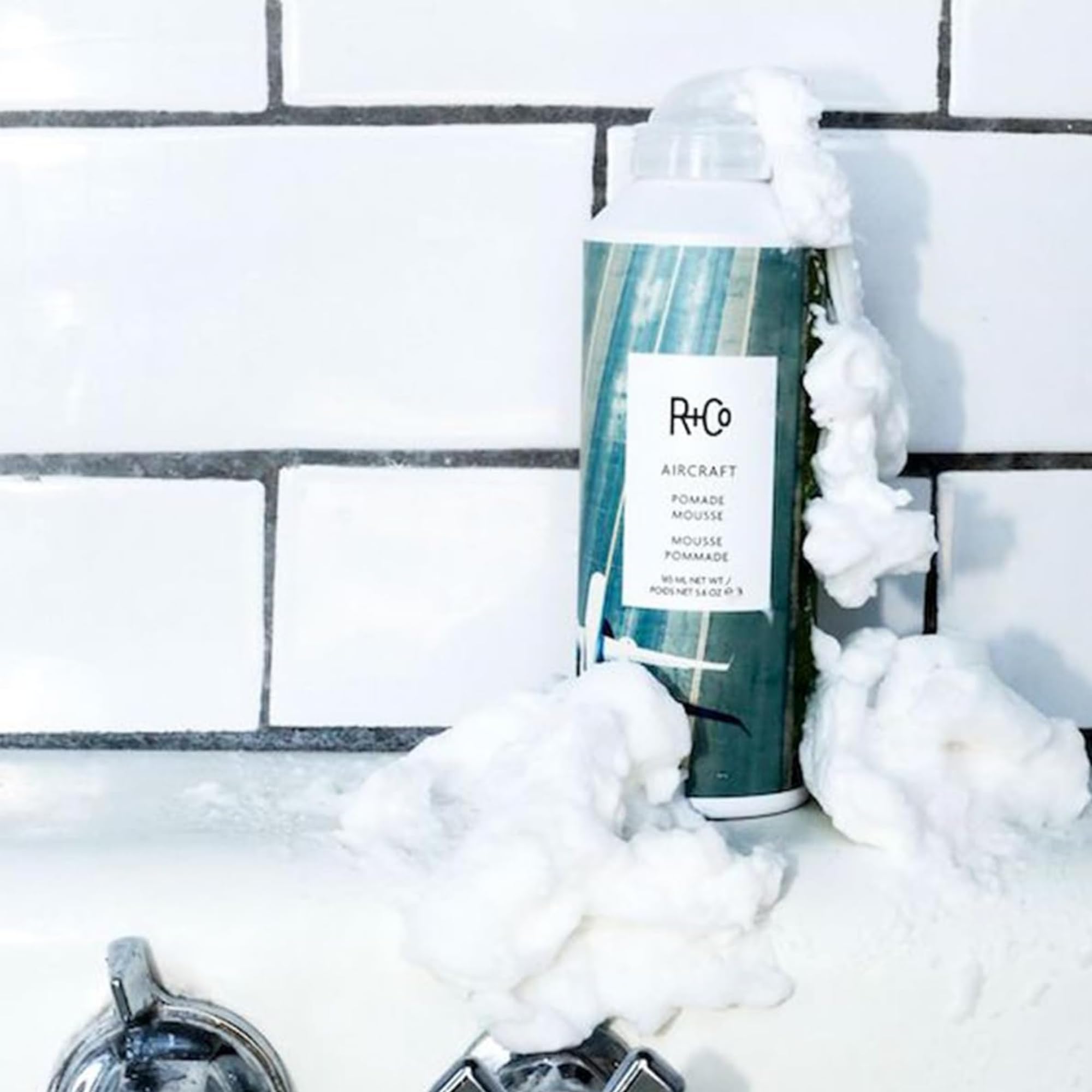 Anti frizz hair mousse bottle showcasing the premium imported branding