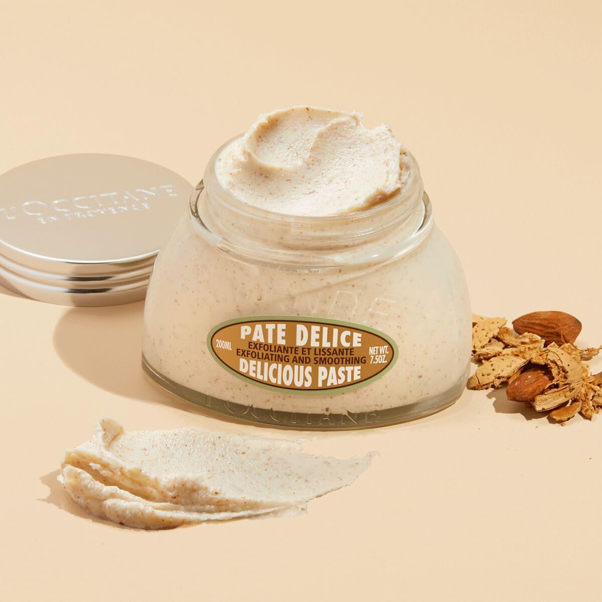 L'Occitane exfoliating body scrub silver lid close up view.