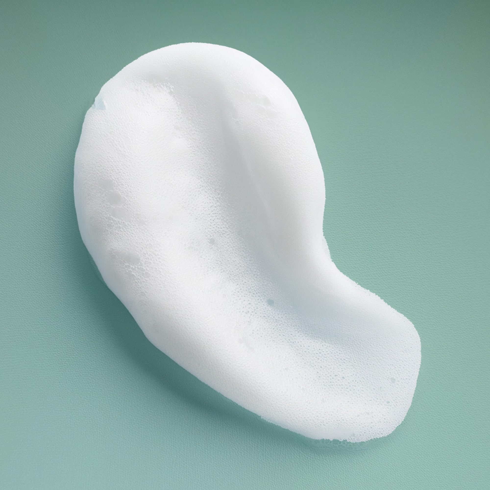 Ouidad professional curl styling foam being dispensed for application