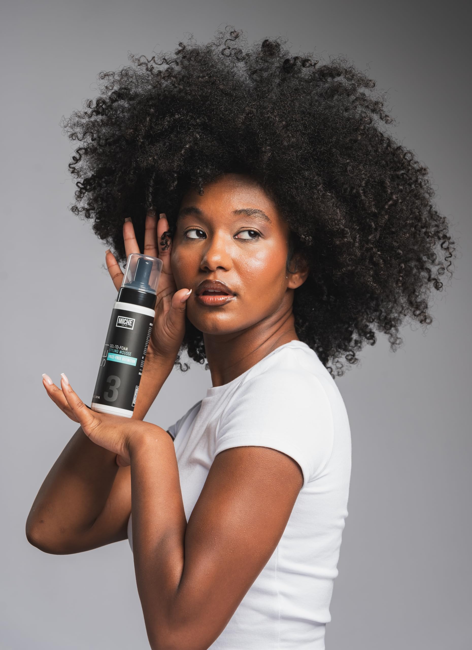 Miche Beauty styling mousse bottle showing botanical ingredient information and usage steps.