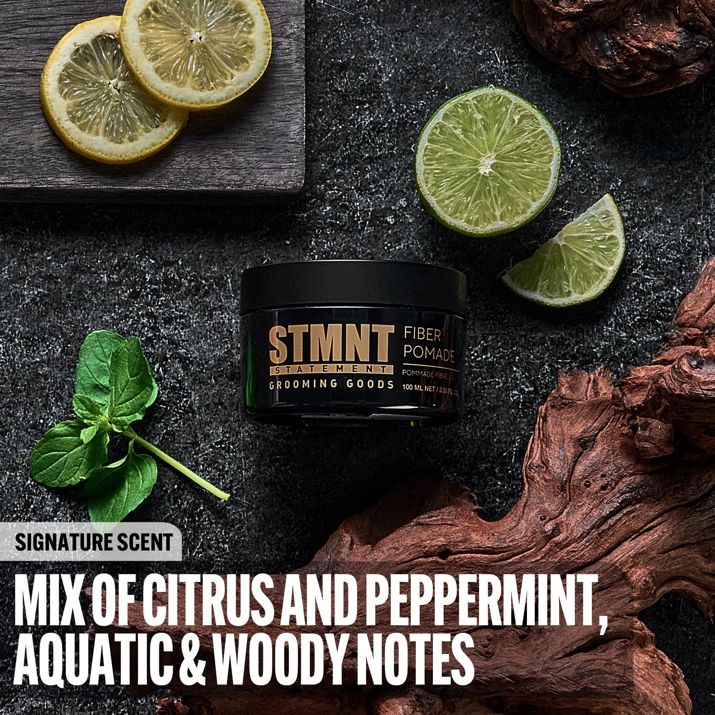 Open jar of STMNT Fiber Pomade displaying the gold colored elastic fiber formula texture