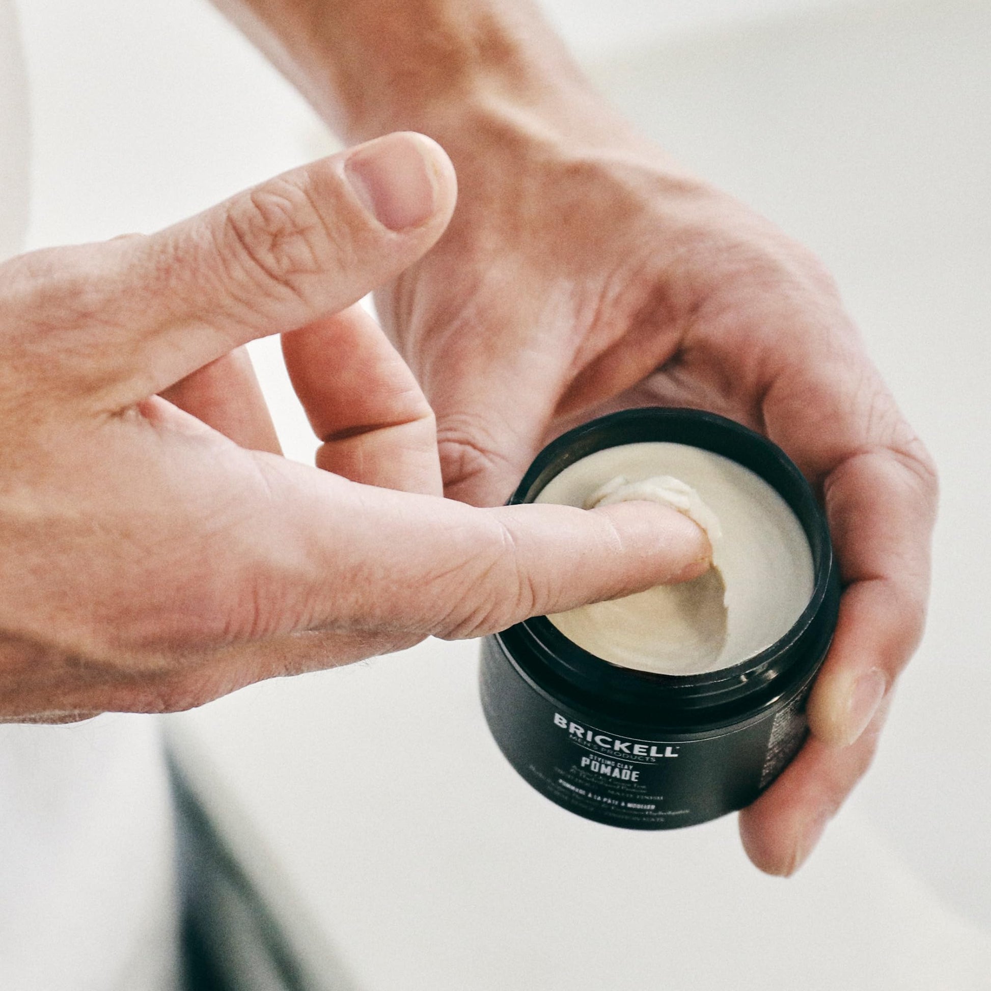 Brickell Men's Products imported premium grooming clay showing two ounces net weight