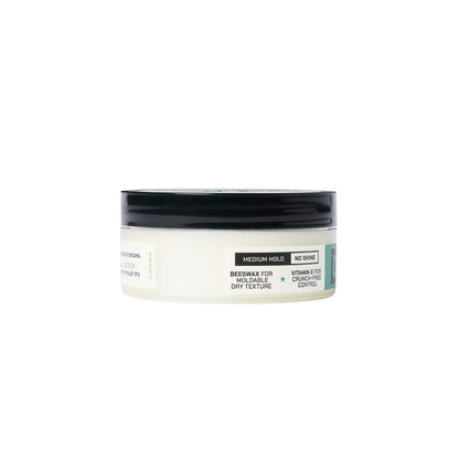 Man applying Duke Cannon styling putty to hair