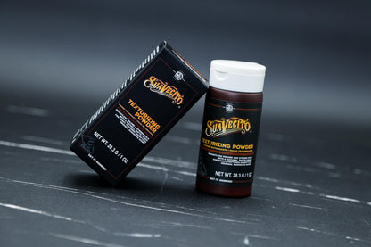 Hand applying Suavecito volumizing powder to hair roots