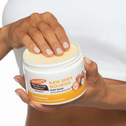Applying Palmer's raw shea butter balm to dry elbow skin