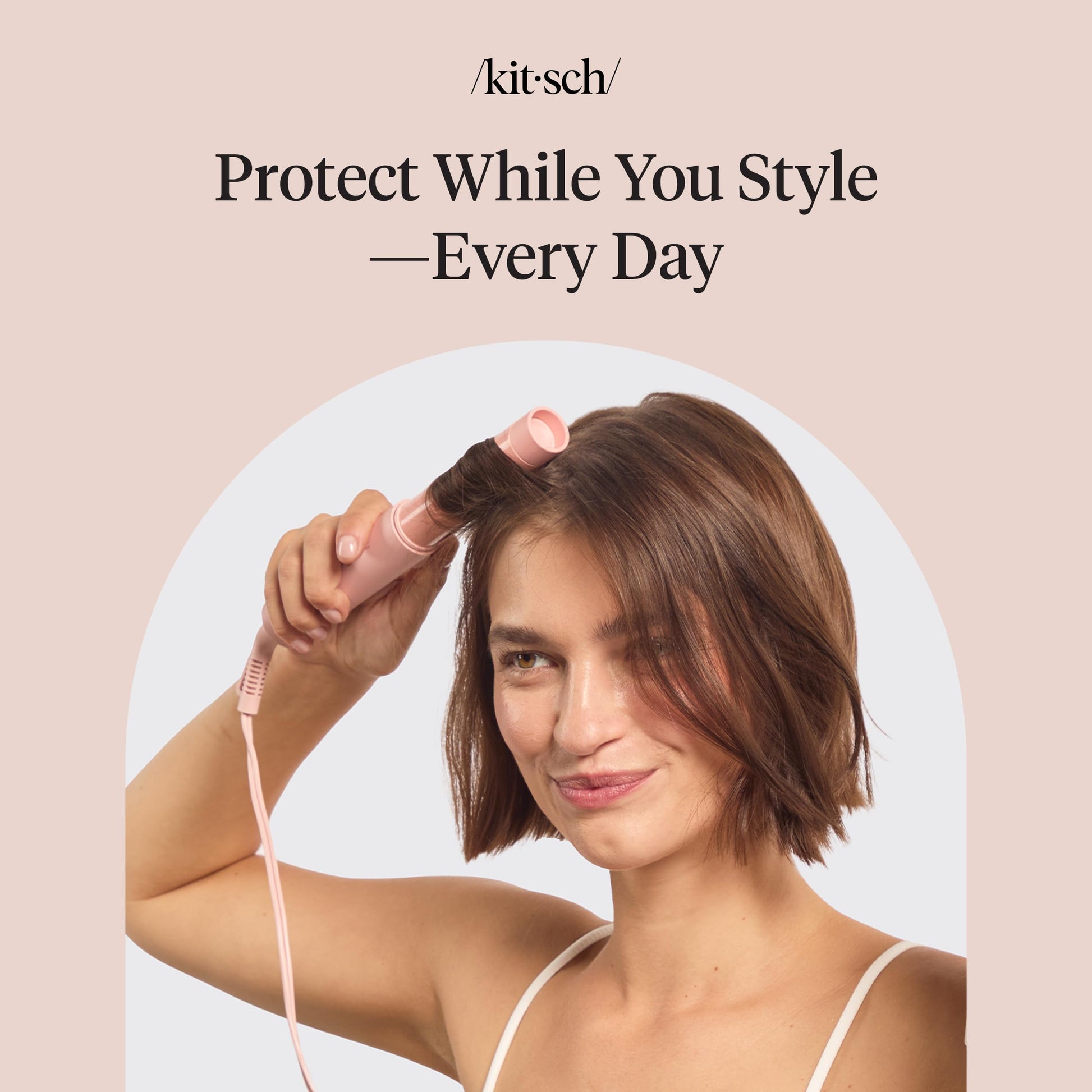 Model applying Kitsch heat protectant mist before blow drying hair