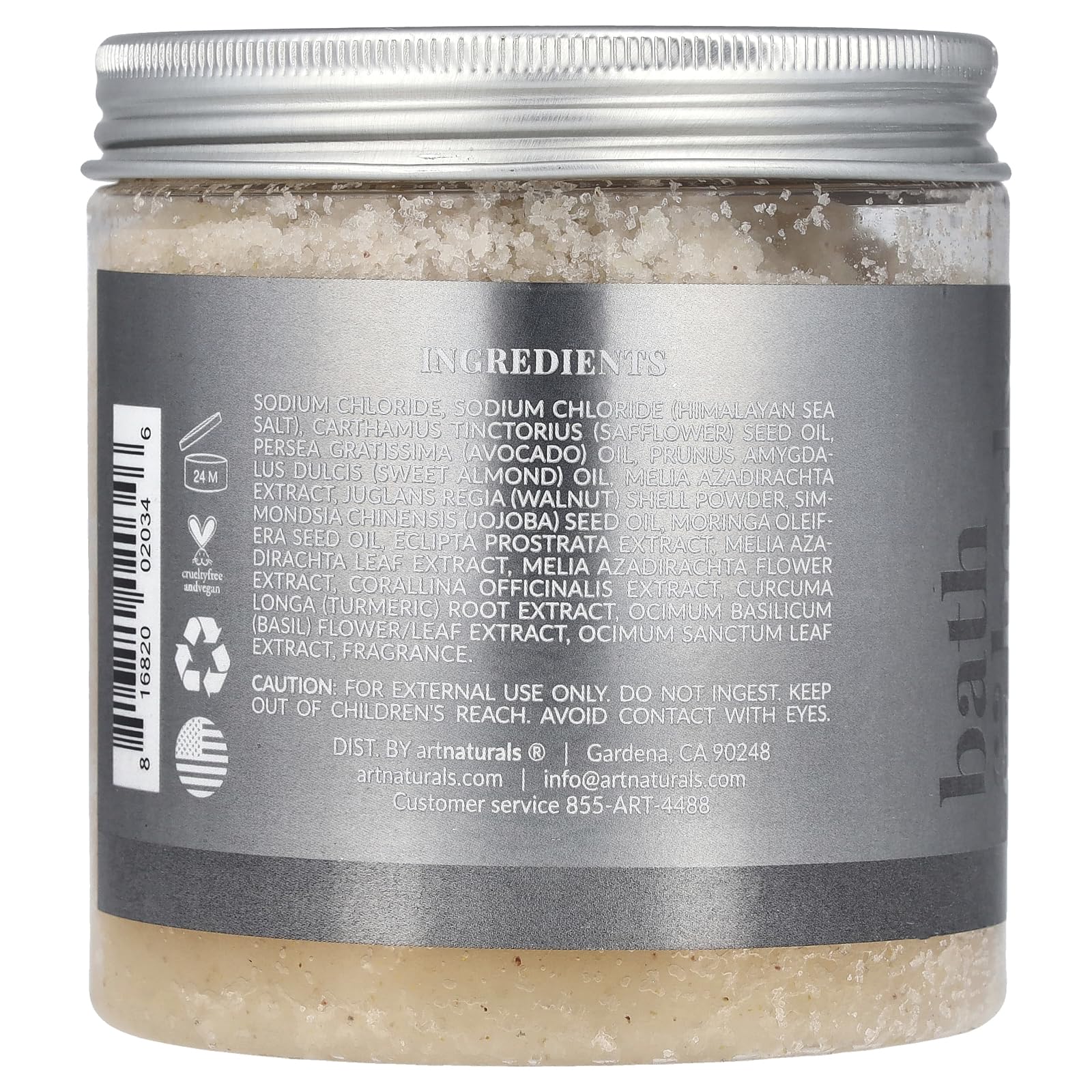Close up shot of artnaturals pink Himalayan salt scrub texture highlighting embedded jojoba oil and shea butter ingredients.
