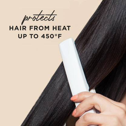 Hair Food heat protectant spray being held in hand